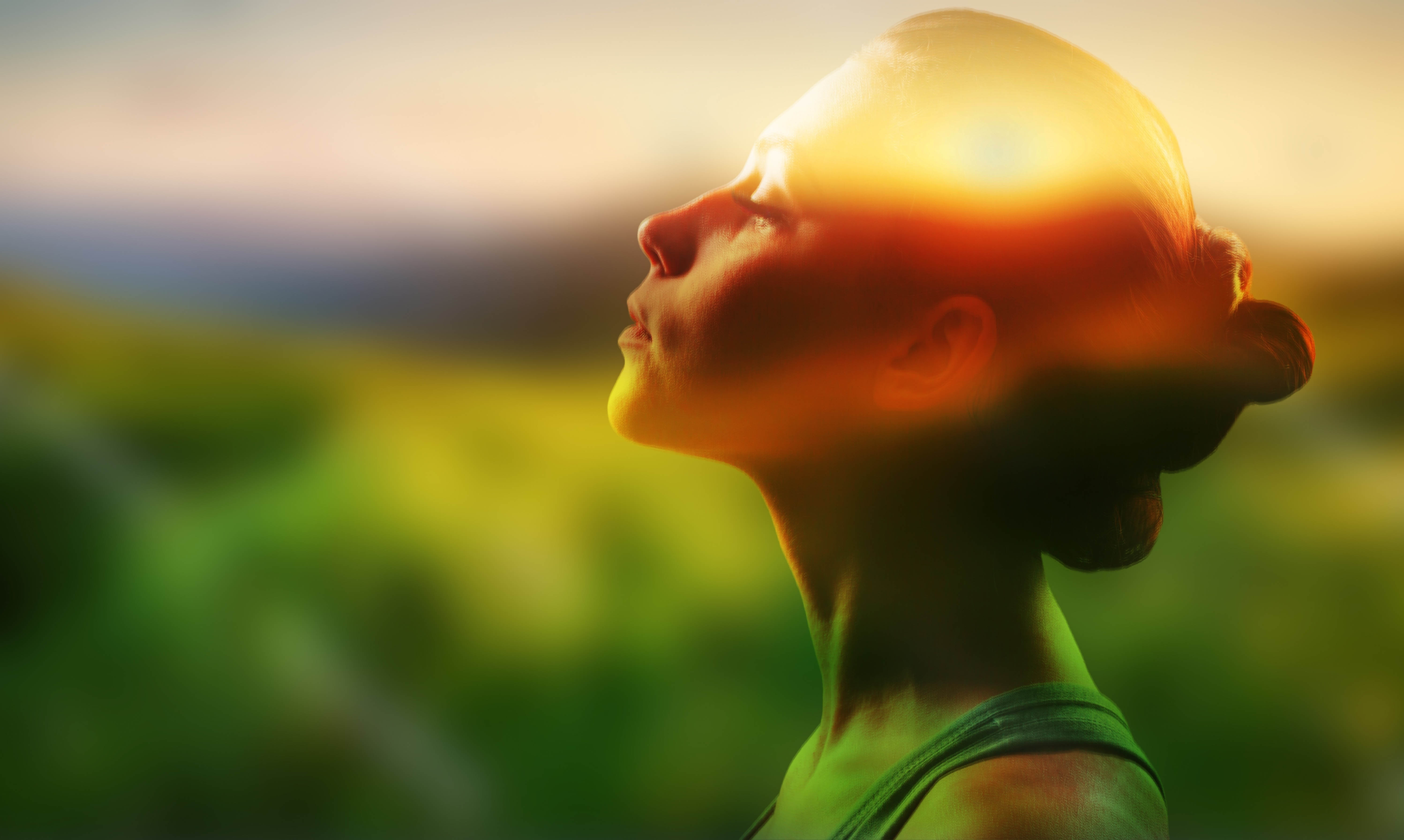 Woman with her eyes closed and face tilted towards the sun, showing her gratitude for life Woman with her eyes closed and face tilted towards the sun, showing her gratitude for life